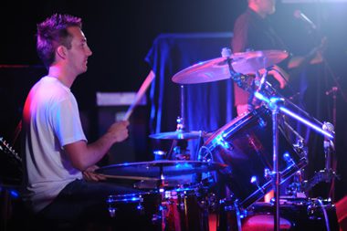 Drummer playing his drum kit