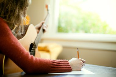 Improve Your Lyric Writing - Girl writing a song