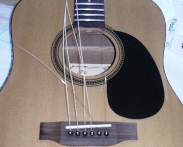Acoustic guitar midway through a restring